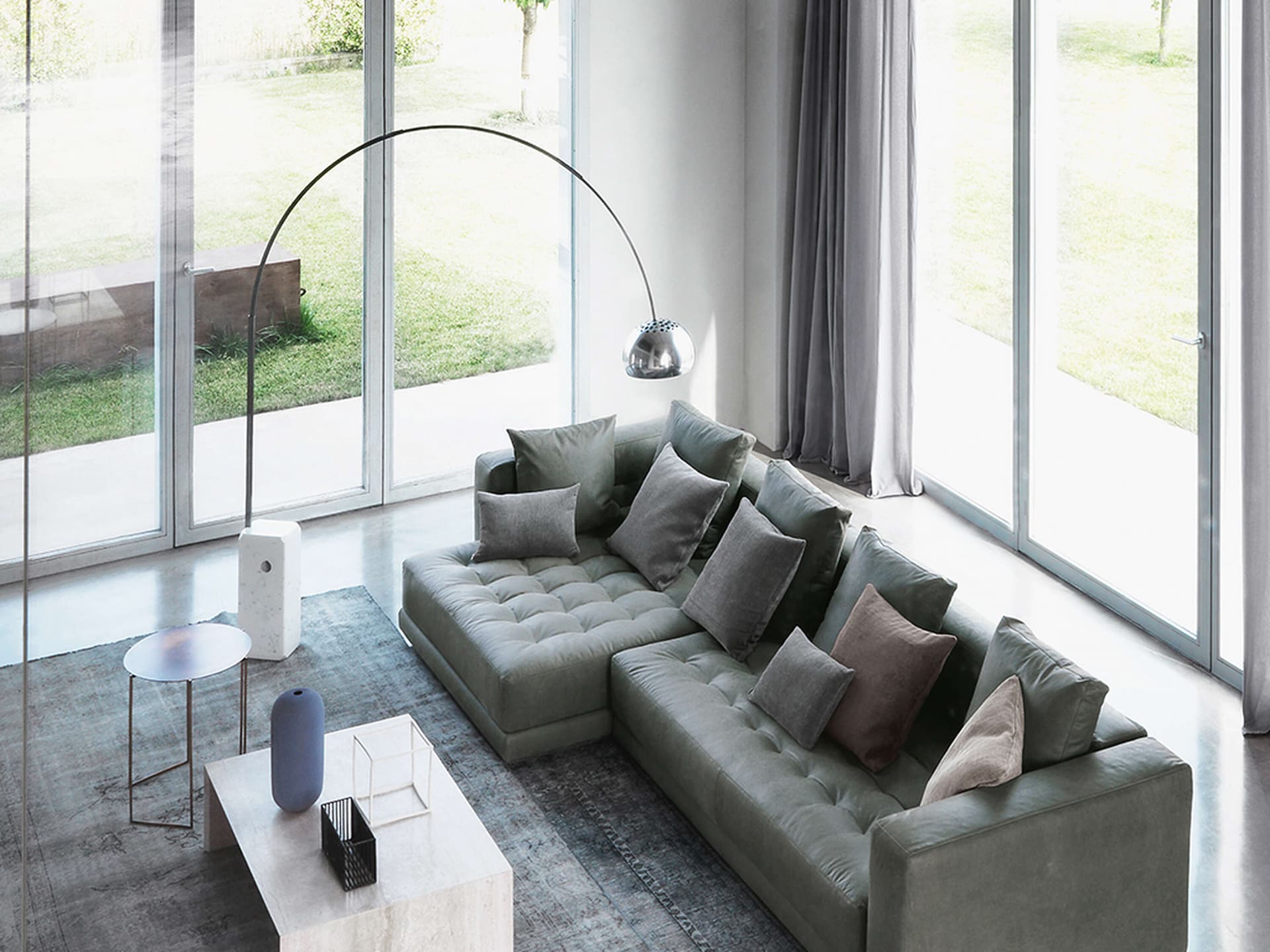 Modern interior featuring Flos Arco lamp with cosy seating.